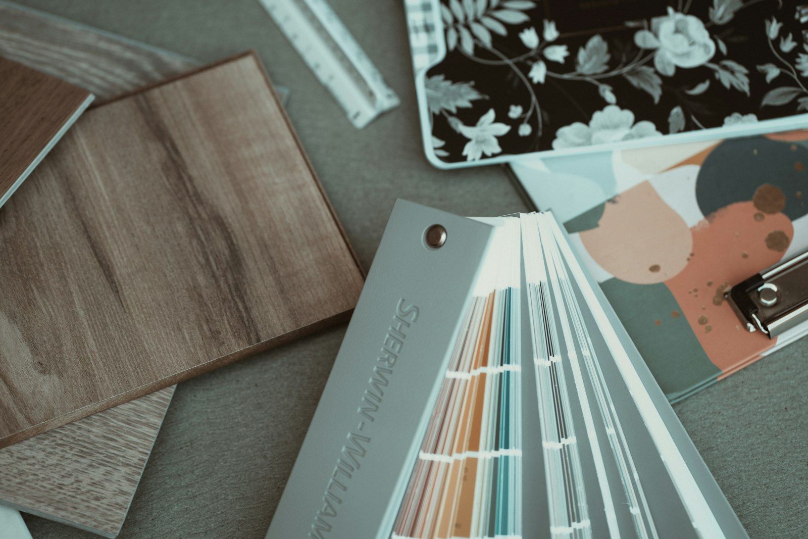 Paint fan deck and material samples on a table