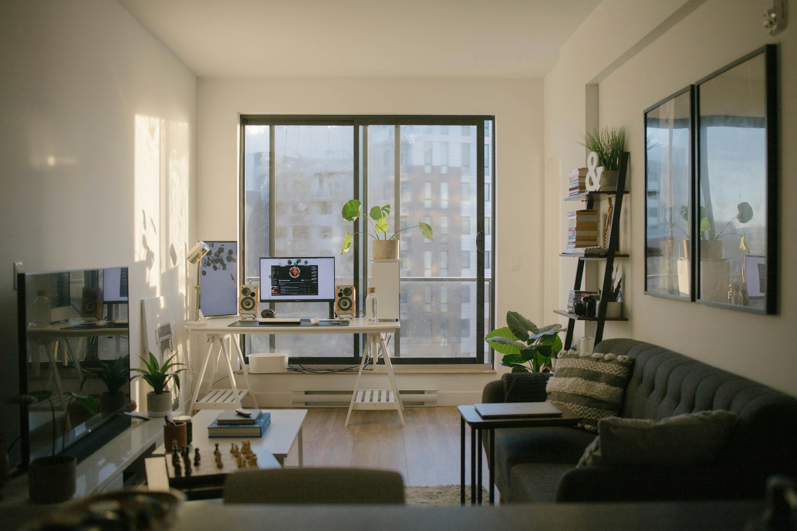 Small sunlit living room with a sofa and a compact work desk