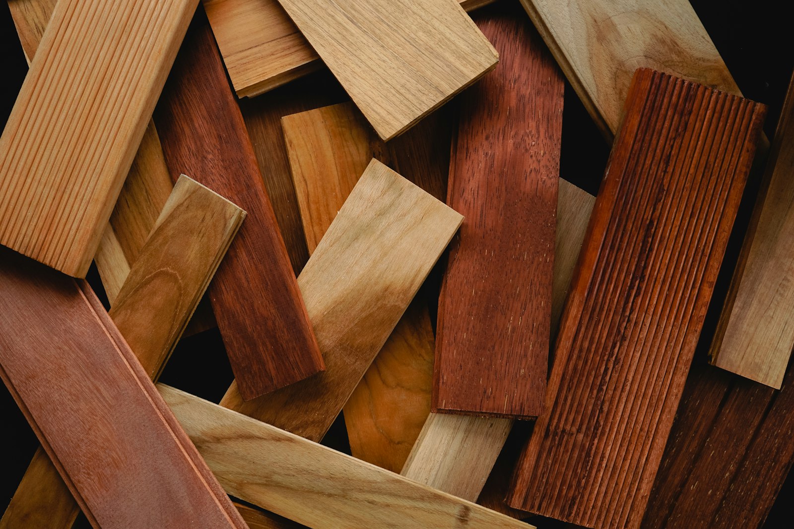 Pieces of wood in different tones and grains laid out as flooring samples